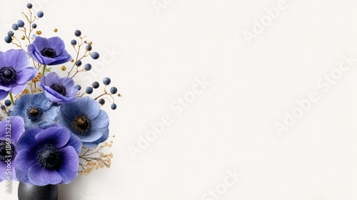 Beautiful arrangement of purple flowers in a simple vase on a light background during daylight