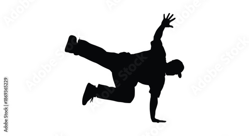Dynamic breakdancer in mid air pose captured as a striking silhouette