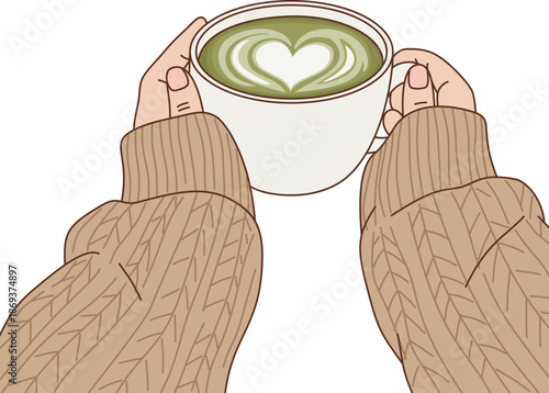 Cozy Hand Holding Hot Matcha Green Tea Latte with Heart Latte Art in White Cup Wearing Knitted Sweater