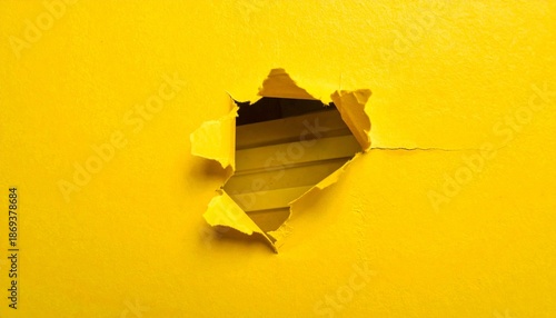 Torn yellow paper revealing striped yellow background.