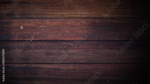 Warm detailed shot of dark brown wood grain with small particles floating for background use
