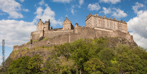 The panorama view of walls and towers of Edinburgh castle western defences with national war museum, cartsheds and new barracks taken from west Princes street gardens. Edinburgh, Scotland, UK