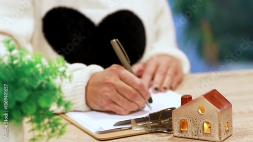 hand writing on desk with house