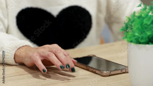 hand holding mobile phone waiting for a message or reply