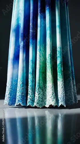 Vibrant fabric displays an abstract underwater scene with coral patterns. Flowing blue and green hues create a serene, elegant textile design.