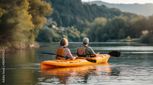 Senior couple kayaking on calm river active aging outdoor recreation and retirement lifestyle
