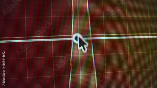 Close up macro capture of a computer monitor during video color grading as the mouse cursor adjusts a saturation curve on a grid interface showing pixels and control points