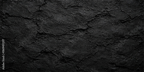 Aged black and white grunge texture background featuring a rough cracked cement wall surface with an antique vintage pattern and dark weathered stone material