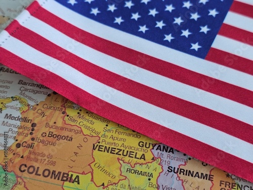 Flag of the United States placed on a map featuring South America including Venezuela and Colombia concept © Nadzeya