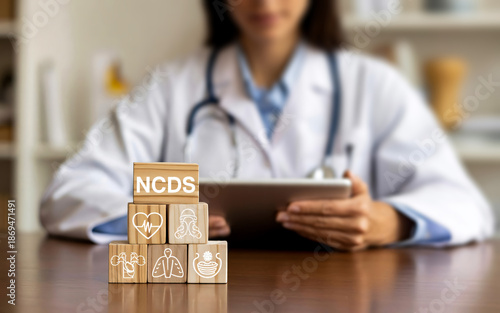 Non Communicable Diseases NCDs Medical Concept with Doctor and Wooden Blocks