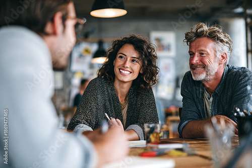 Casual creative meeting in a cozy café: smiling colleagues brainstorming ideas and collaborating in a relaxed modern workspace