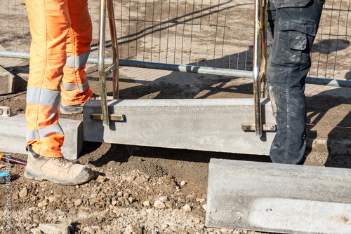 Setting road border kerb stone before laying new asphalt