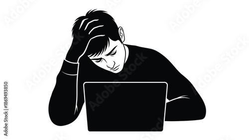 Frustrated young man holding his head while looking intently at a blank laptop screen indoors