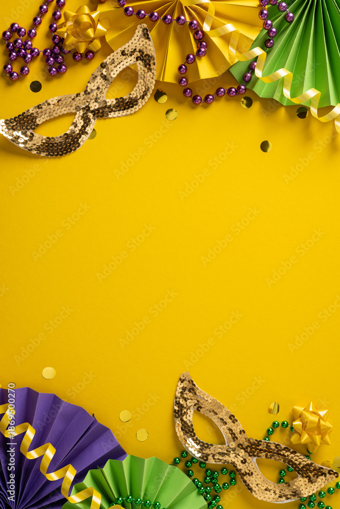 Fototapeta premium Vibrant vertical Mardi Gras scene featuring sequin masks, purple green gold beads, and paper decorations against a bold yellow background, conveying festive energy and festive mood for celebration