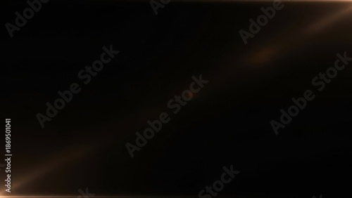 Abstract cinematic golden light flares softly illuminating a deep black void with elegant ethereal