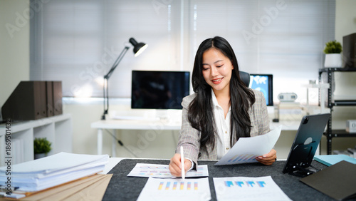 Business woman, documents and accountant check report for information, financial data or analysis. Paperwork, auditor and female professional checking for auditing, planning or bookkeeping in office.