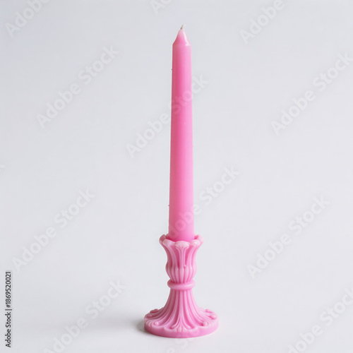 Pink taper candle isolated on white background for romantic and special occasions