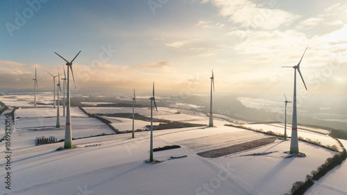 Billede på lærred Windless wind turbine in snow, dark doldrums or wind lull in winter, renewable s