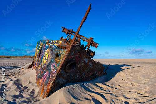 Wreck of the mussel dredger “Pionier,” which ran aground in 1967 on the North Sea island of Norderney. The rusty remains of the ship at the eastern end are sinking into the sand and are a popular dest