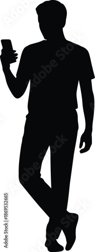 Silhouette of a man in at-shirt and pants holding a smartphone with crossed legs male person