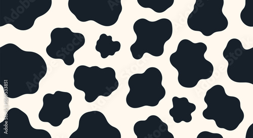 Simple and fun seamless cow print pattern with black organic spots on a creamy white background for a classic farm animal texture.