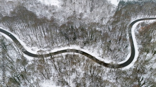 Winding Winter Road Through Snow-Covered Forest, Aerial View