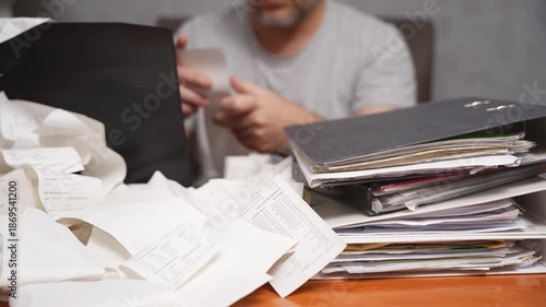 Home Office Tax Preparation. Home office scene with stacks of papers, receipts, and binders during tax preparation. Concept of freelance accounting, personal business, and financial responsibility.
