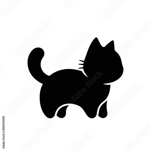 Simple black silhouette of a cute cartoon kitten standing and looking to the side with its tail curled up and whiskers visible on a clean white background
