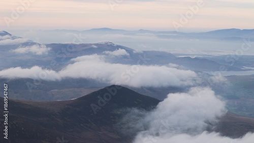 Spectacular 4K aerial video of flying above highest mountain ridge in Ireland - McGillyCuddy Reeks at sunset, with breathtaking views around, Kerry mountains, Ireland