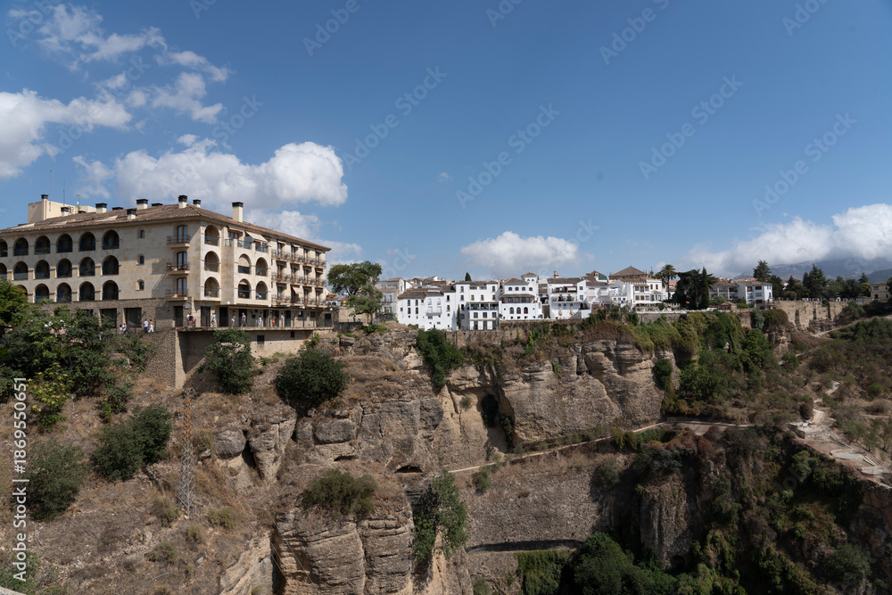 Fototapeta premium Buildings on a cliff with blue sky.. Ronda, Málaga, Spain