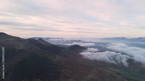Spectacular 4K aerial video of flying above highest mountain ridge in Ireland - McGillyCuddy Reeks at sunset, with breathtaking views around, Kerry mountains, Ireland