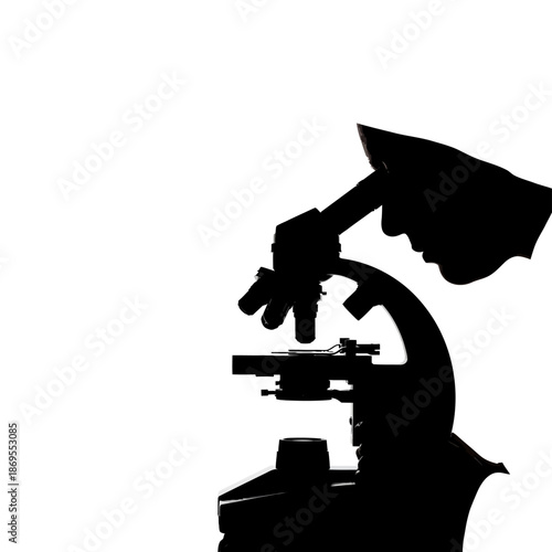 Silhouette of a hand using a microscope for scientific research.
