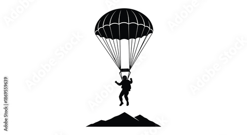 A skydiver descending with a parachute over mountains a striking silhouette