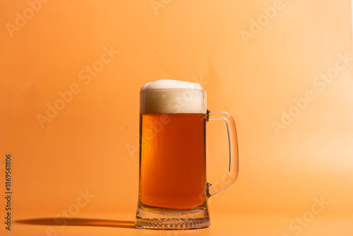 a glass of beer on a beige background