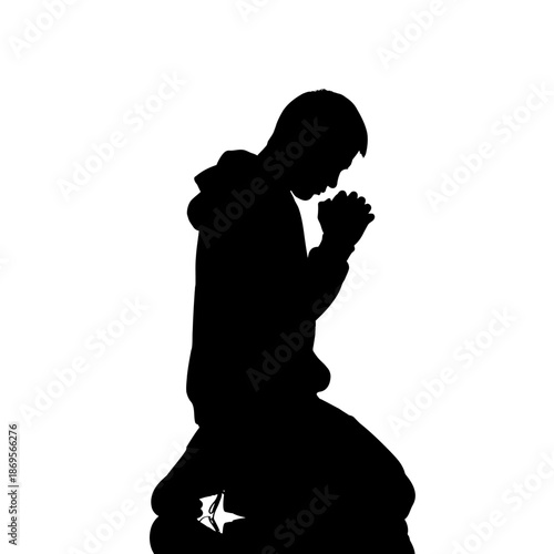 Silhouette of a Person Kneeling in Prayer with Hands Clasped.