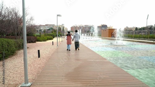 Unrecognizable couple walking together by a fountain on Valentine’s Day	