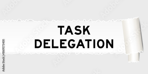Ripped gray paper background that have word task delegation under torn part