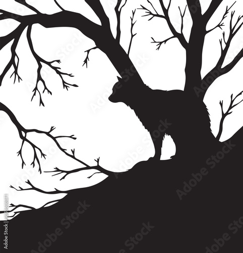 Silhouette of a wolf standing on a hill beneath bare tree branches