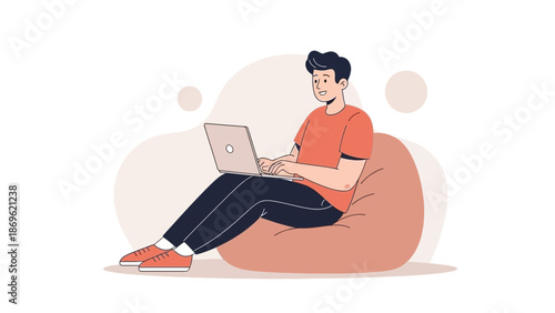 Young Man Relaxing on Bean Bag Chair Using Laptop Computer