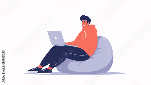 Young Man Sitting on Bean Bag Chair Working on Laptop Computer