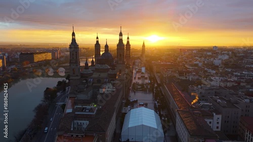 Aerial View Capturing Sunset Glow Illuminating Cathedral Domes And Tranquil River Reflections. Zaragoza. Spain 