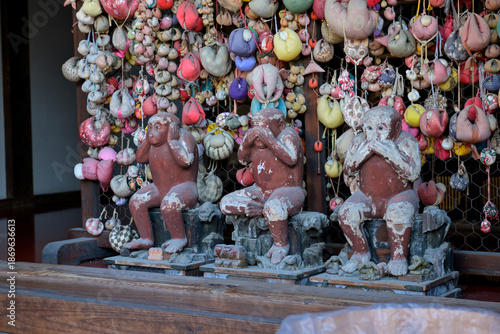 Sculptures of monkeys and colorful balls at Kyoto Temple Courtyard – Traditional Japanese Shrine with Autumn Foliage