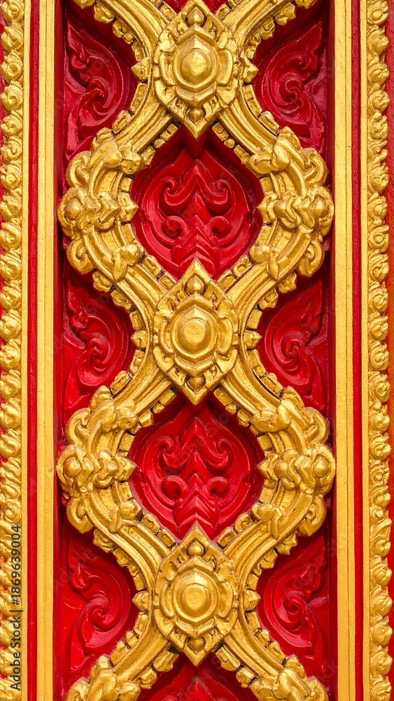 Fototapeta premium Intricate Golden Thai Carving on Red Background.