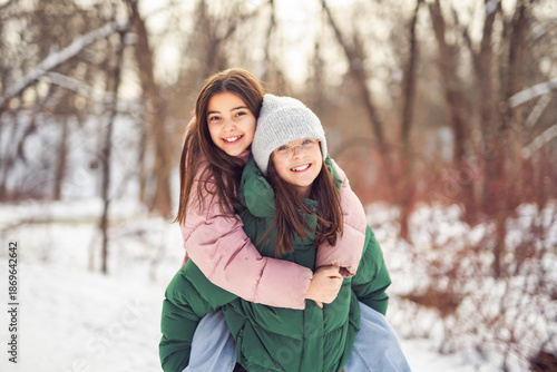 Two friends outdoors in a cold winter weather.