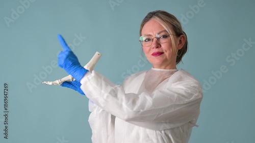 Female doctor holding foot skeleton model for medical consultation
