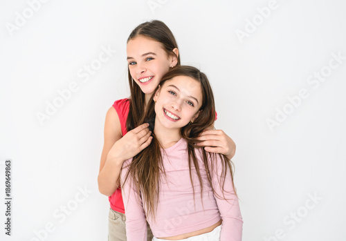 Two cute and Young pre teen girl on studio white