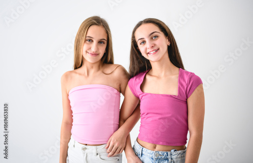 Two cute and Young pre teen girl on studio white
