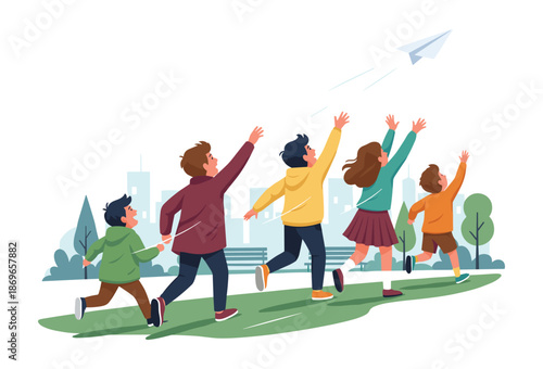 Family running and flying paper airplane in city park