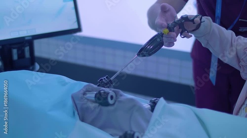 A little girl is learning to become a doctor on a simulator – laparoscopy is a modern method of minimally invasive surgery through small openings