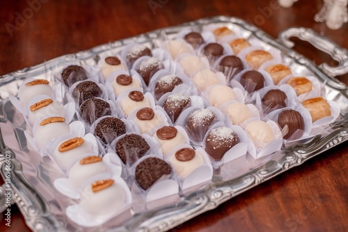 Dessert table with brigadeiro (Brazilian chocolate fudge balls), walnuts, and coconut
